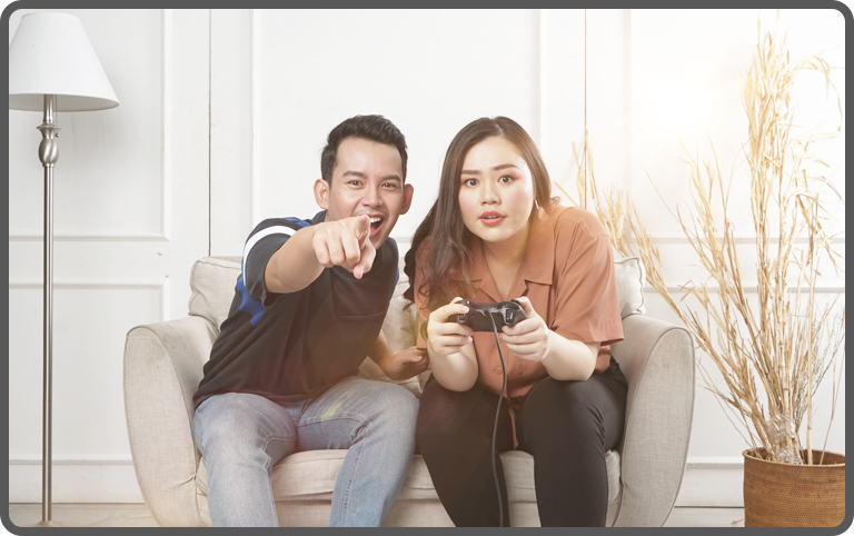 Couple gaming in a light room to minimise motion sickness