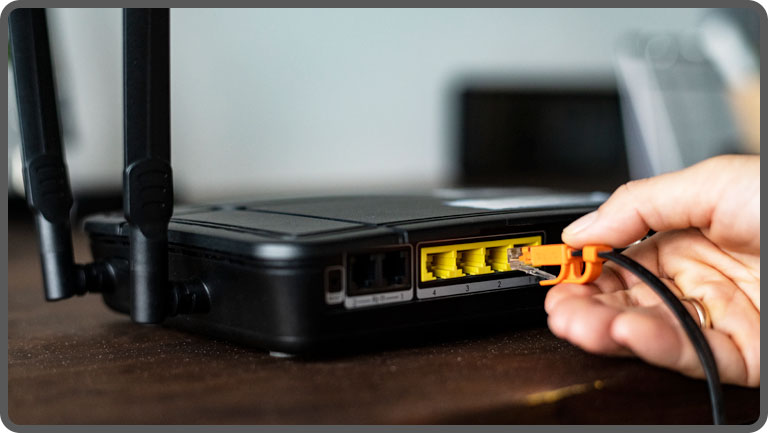Ethernet cable plugged into router for faster internet speed
